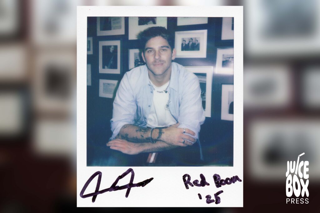 GUNNAR posing in front of a photo collage wall