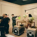 Aidan Zamiri and Charli xcx get ready to film a scene on the set of "The Moment"