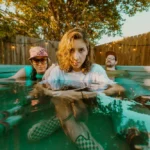 Press photo of Weakened Friends sitting in a pool