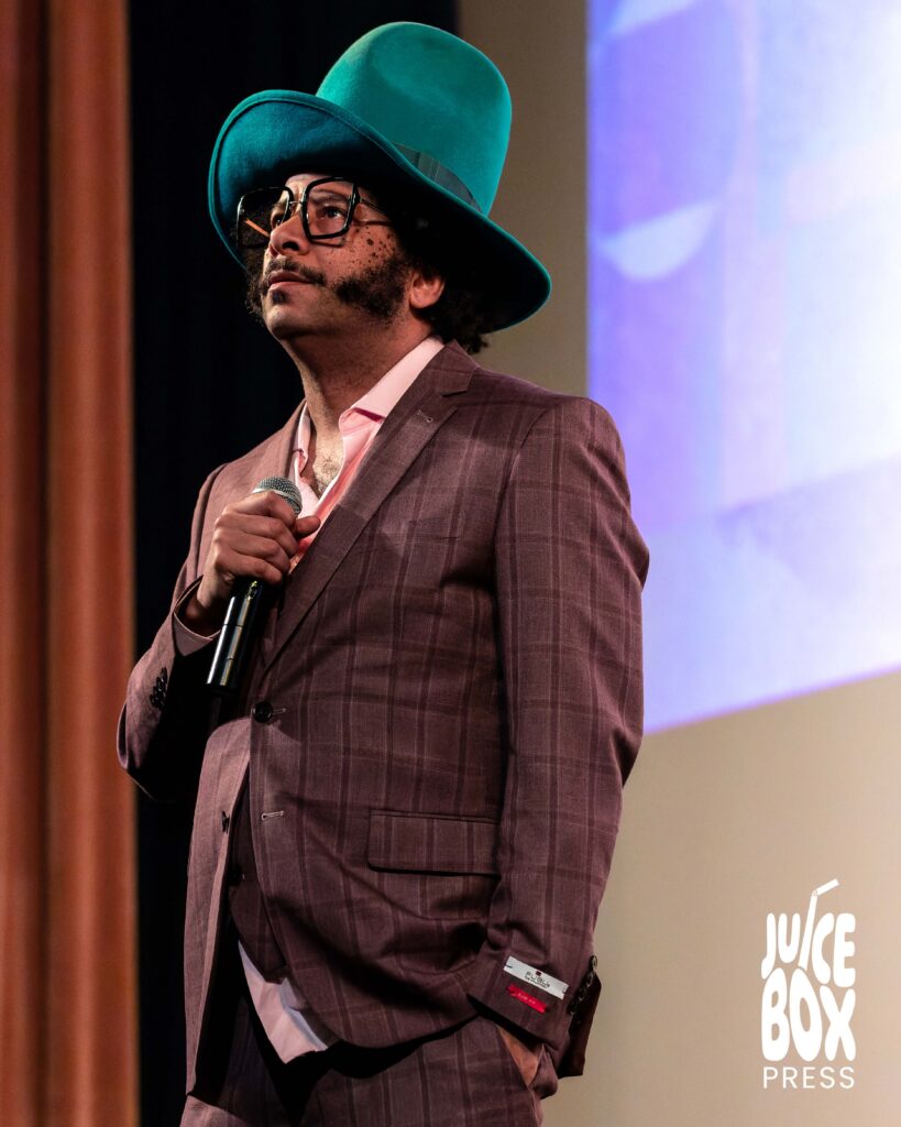 Boots Riley answering audience questions during a Q&A at the Somerville Theatre