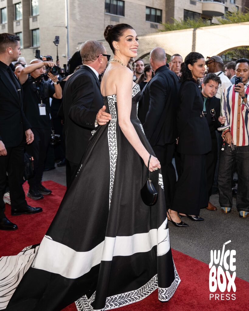 Anne Hathaway poses for photos departing The Pierre Hotel for the Met Gala.